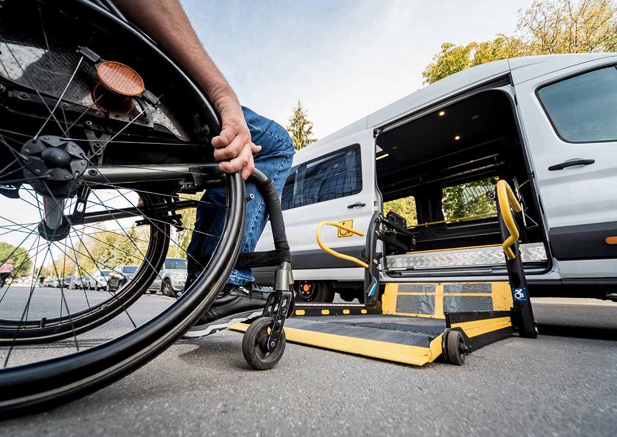 Wheelchair user entering accessible taxi