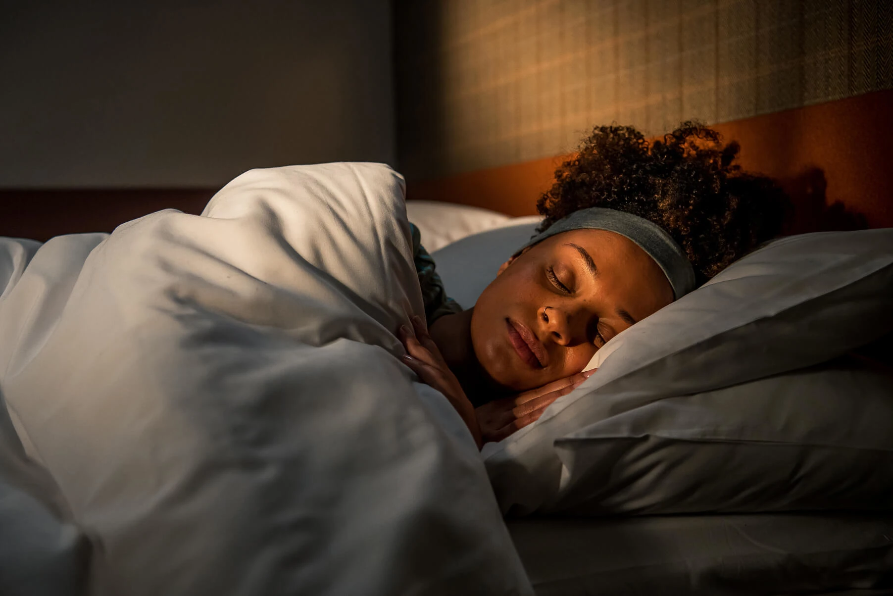 Woman asleep in bed on Caledonian Sleeper