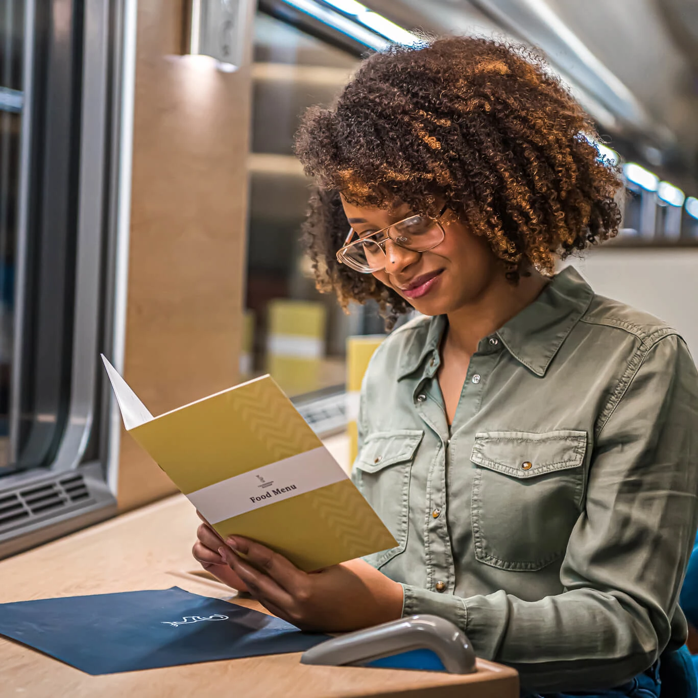 Woman looking at menu in Club Car