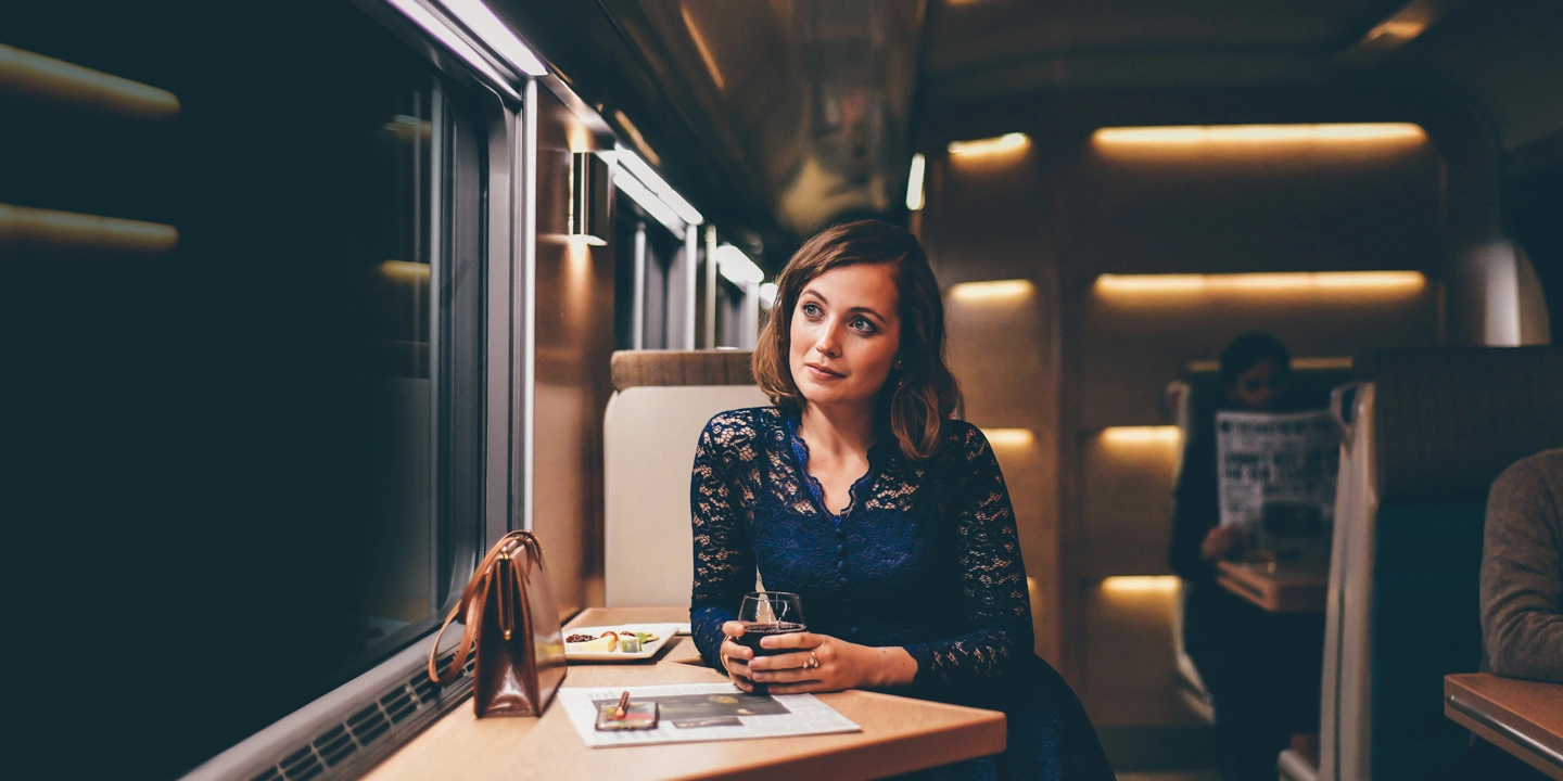 Woman sitting in Club Car looking out of window