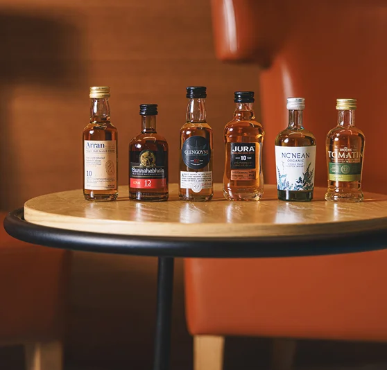Six miniature bottles of Whiskies.