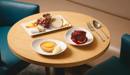 Round table with 3 desserts available on Caledonian Sleeper.