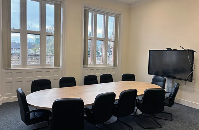 Double aspect room with Boardroom style desk and chairs.