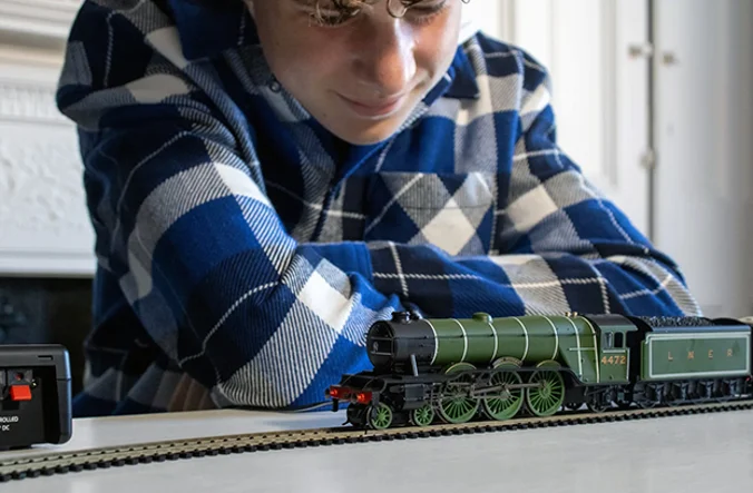 Man looking at his model of the Flying Scotsman