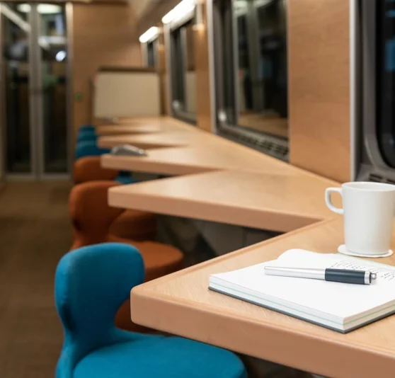 Notebook and cup of tea at seats by window in Club Car