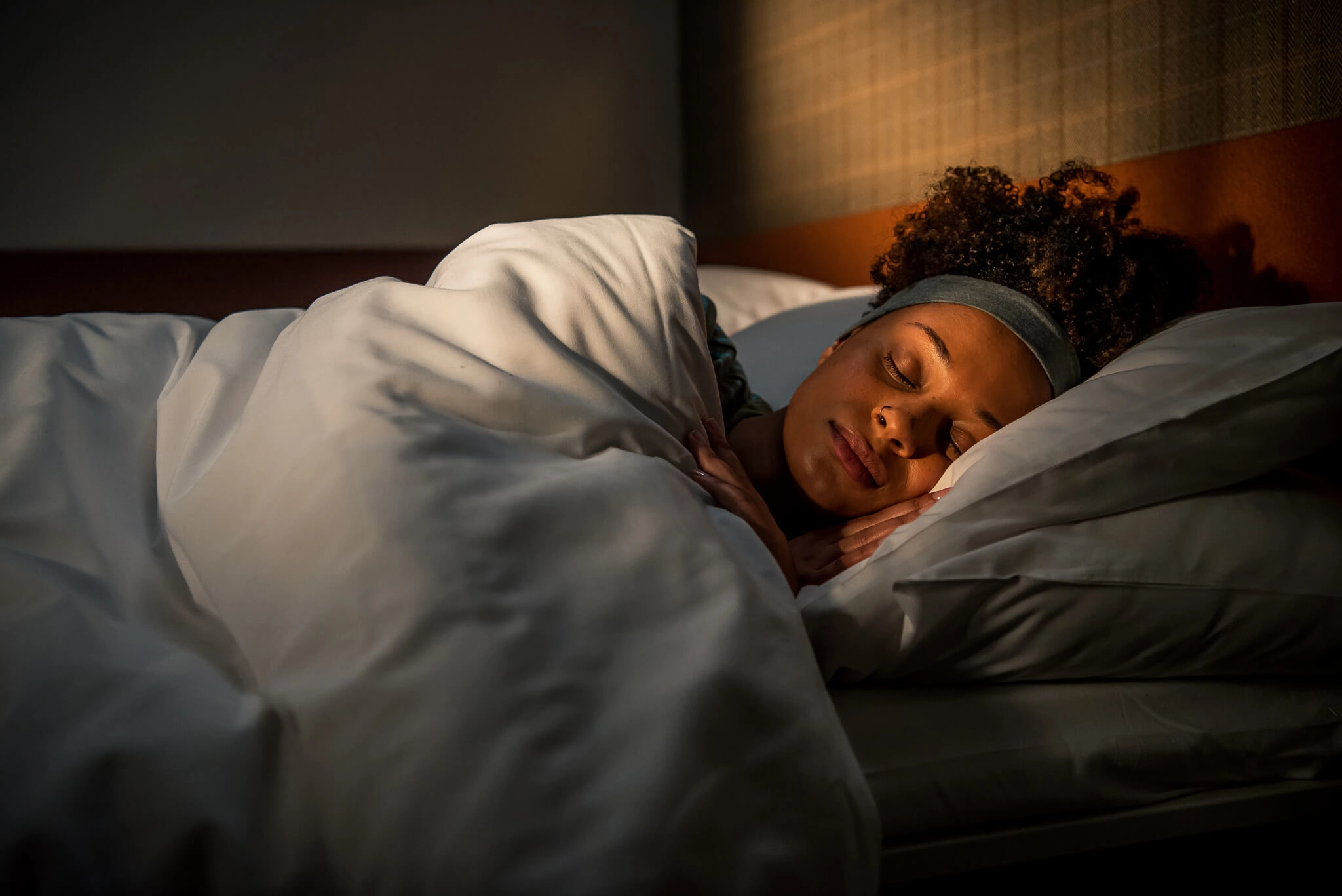 Woman asleep in bed on Caledonian Sleeper