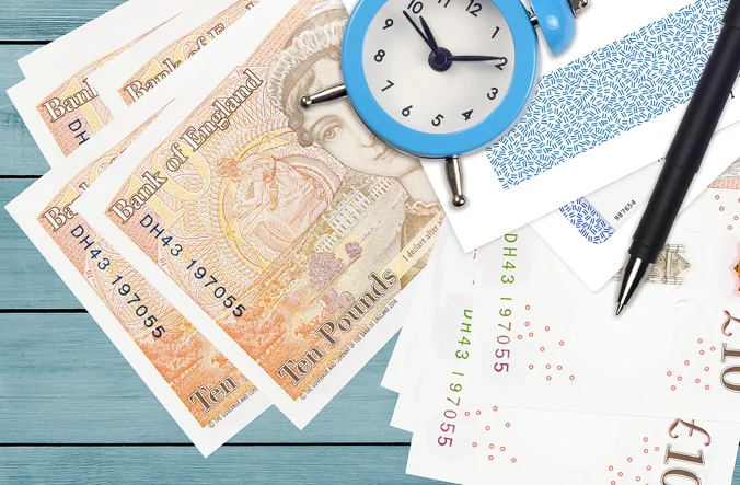 Clock on top of pile of money