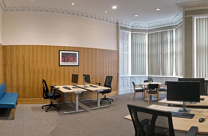 Multiple desks with chairs, showing the hot desks at the Perth meeting and events centre.
